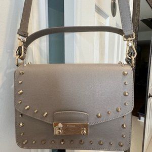 Grey Furla bag with short and long stripe and studs.